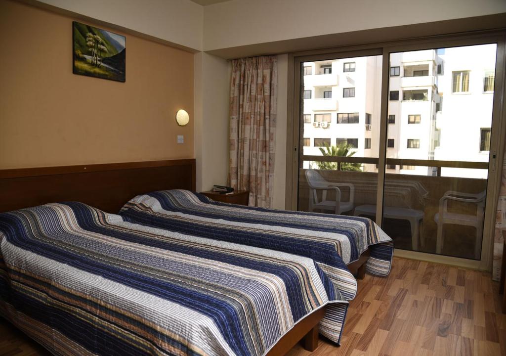 Postel nebo postele na pokoji v ubytování Elysso Hotel