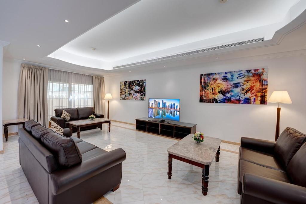 a living room with two couches and a table at J5 Four Bedroom Villa Holiday home in Mirdif in Dubai