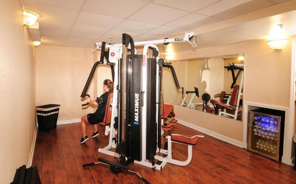 a woman in a gym with a simulator at Holiday Pavilion Resort on the Boardwalk in Myrtle Beach