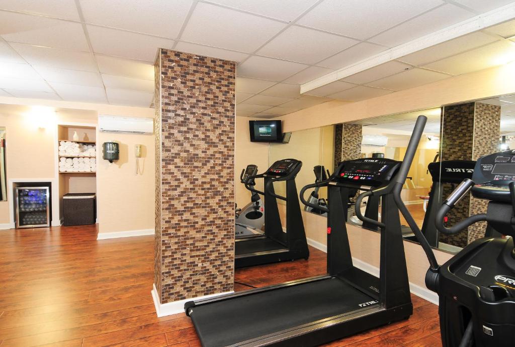 a gym with treadmills and ellipticals in a room at Holiday Pavilion Resort on the Boardwalk in Myrtle Beach