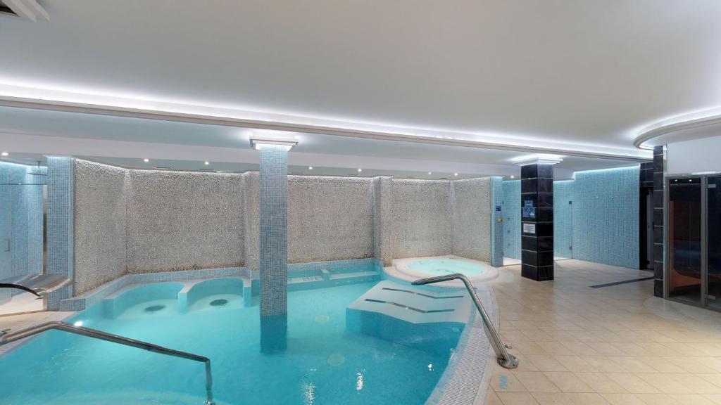 a large swimming pool in a hotel room at HL Suitehotel Playa del Inglés - Adults Only in Playa del Ingles