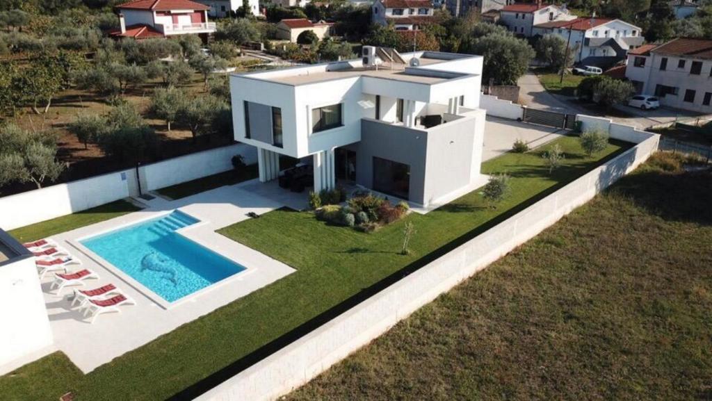 an aerial view of a house with a swimming pool at Villa Lungera in Štinjan