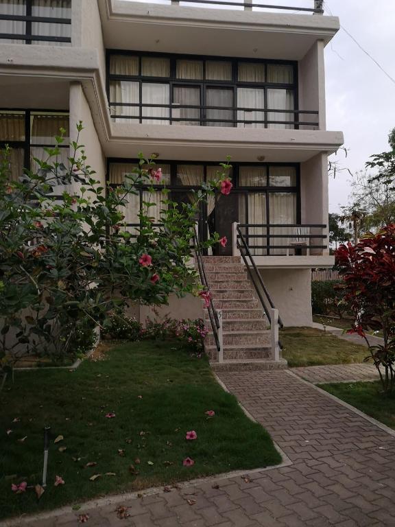 a house with stairs and flowers in front of it at Vistazul Rentals in San Clemente