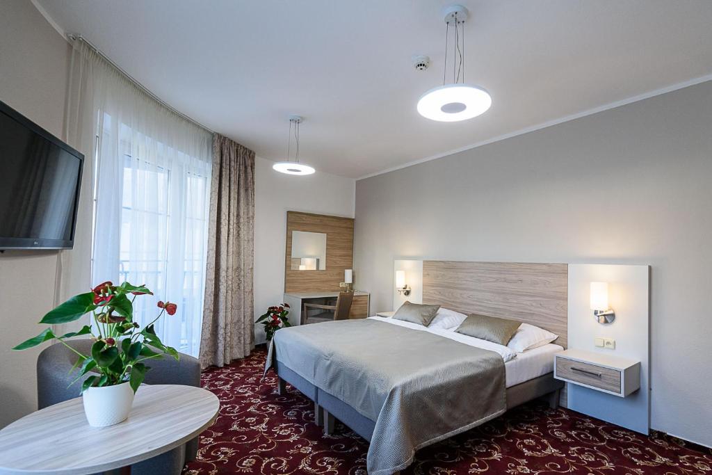 Posteľ alebo postele v izbe v ubytovaní Sport-V-Hotel