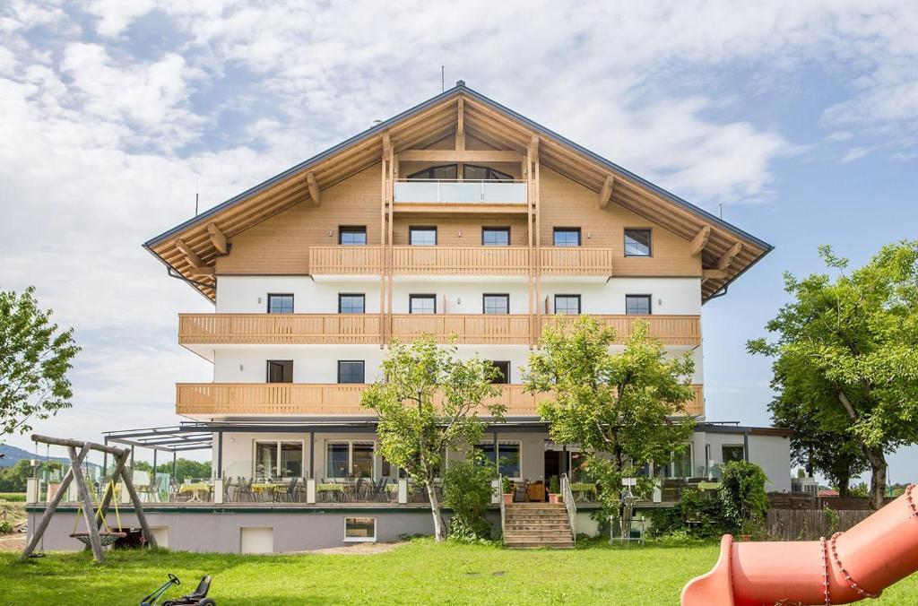 a large building with a gambrel roof at Hotel & Restaurant Rupertigau in Wals