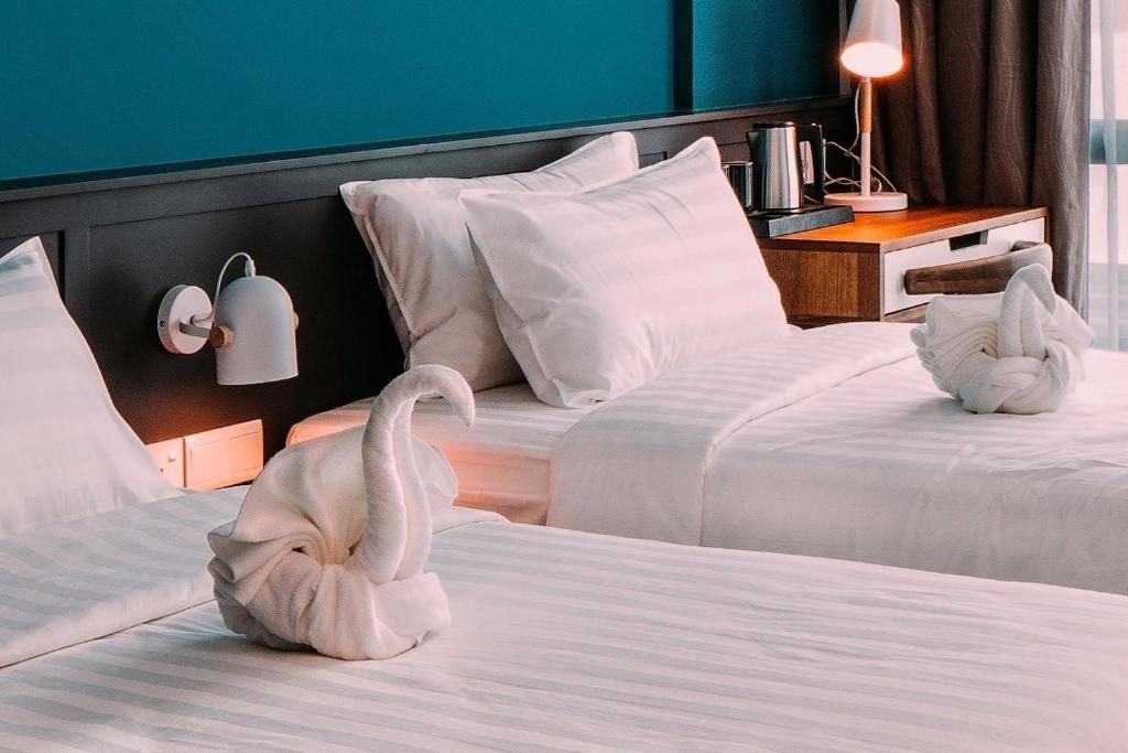 Postel nebo postele na pokoji v ubytování O&G Hotel Parit Buntar