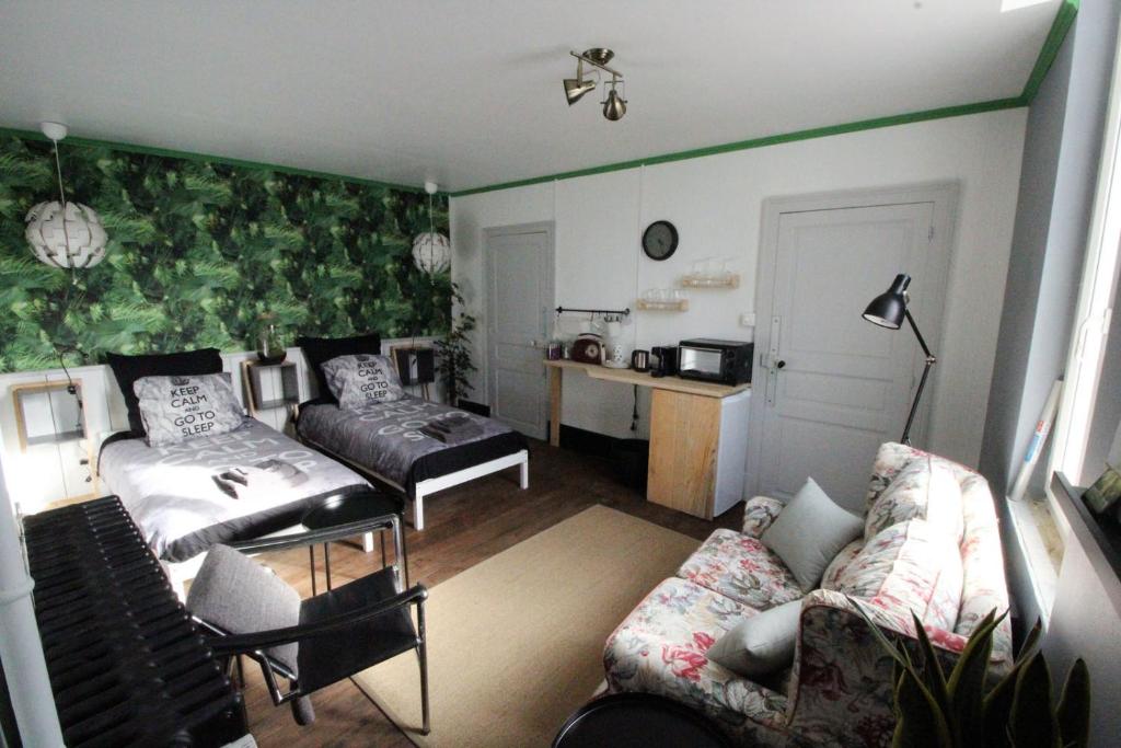 a living room with a couch and a table at Chambre Notaire in Cosne-dʼAllier