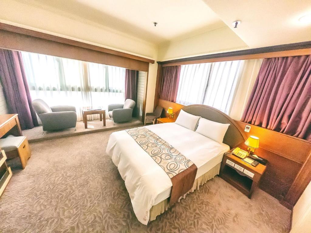 Postel nebo postele na pokoji v ubytování Foung Jia Hotel
