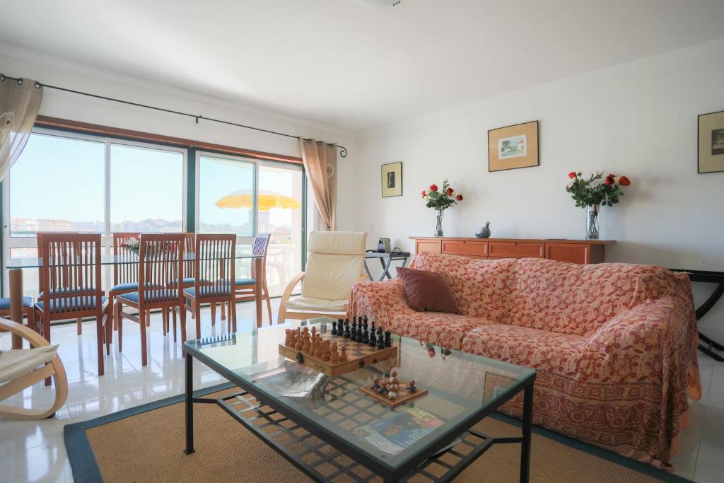 a living room with a couch and a table at Sotto Mayor Residence in Figueira da Foz