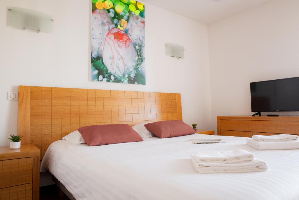 Postel nebo postele na pokoji v ubytování Comfort Aparthotel Mutzig Portes d'Alsace