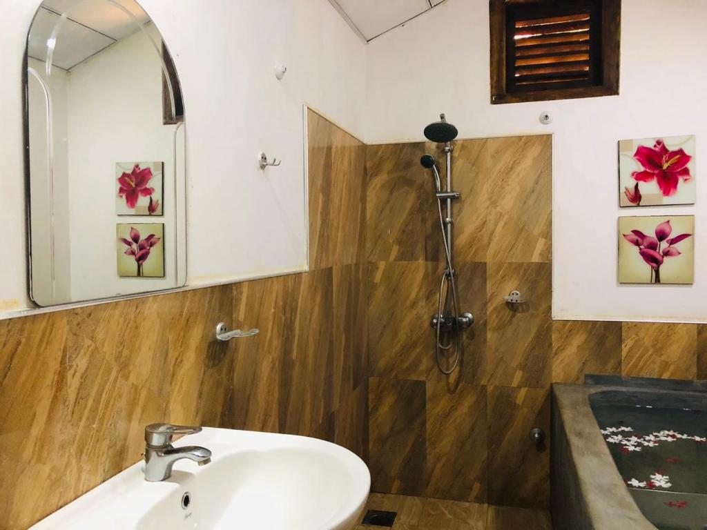 a bathroom with a sink and a mirror at Bangalawa Resort in Habarana