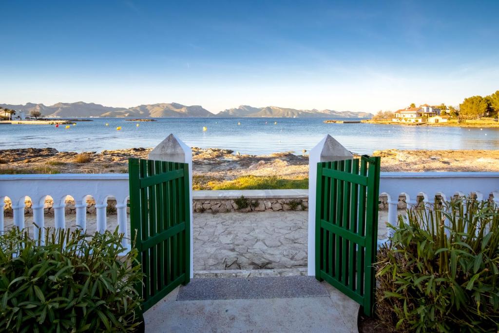 a gate to a house with a view of the water at Villa Ca'n Verd in Alcudia
