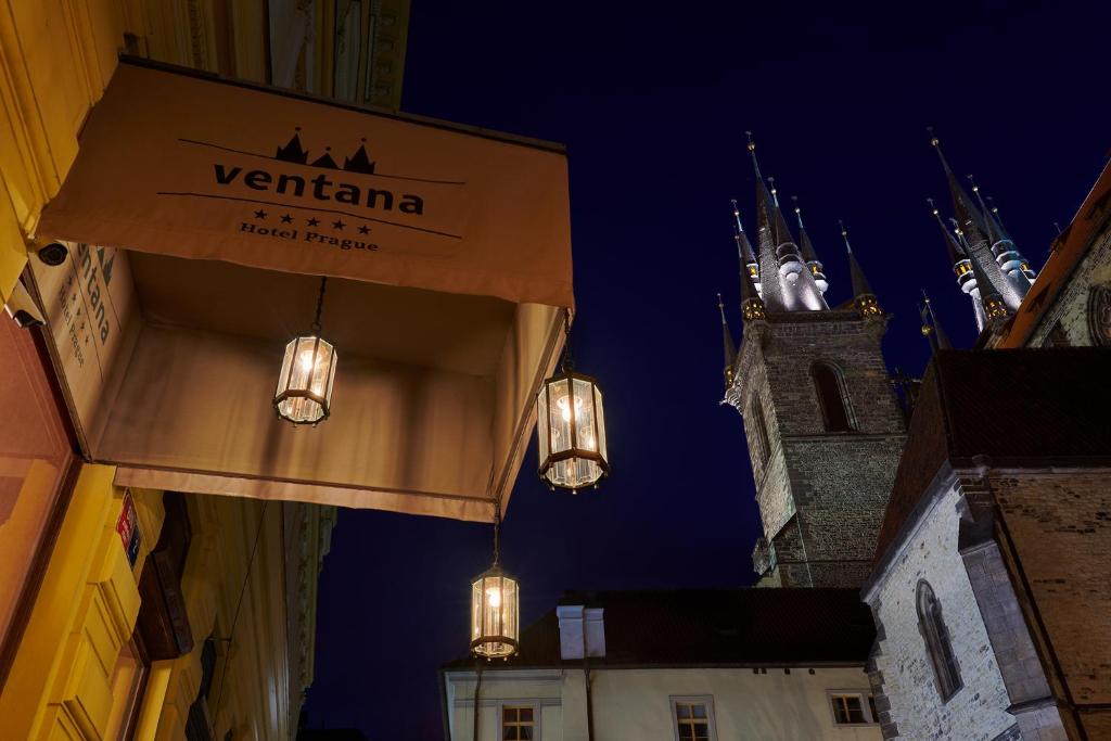 a building with a sign that reads vienna with a clock tower at Ventana Hotel Prague in Prague
