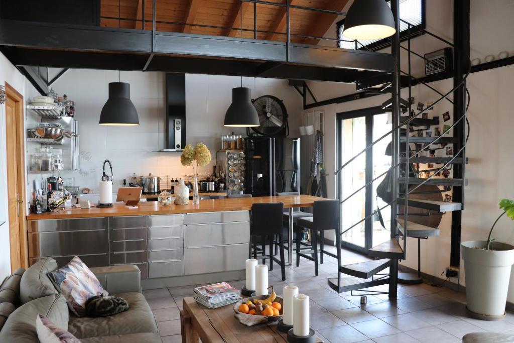 a living room with a couch and a kitchen at Skylark Bed & Breakfast in Grasse