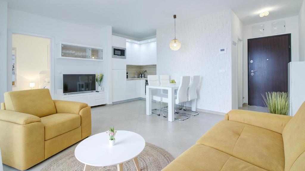 a living room with a couch and chairs and a table at Apartments Luka - Villa Sunce in Senj