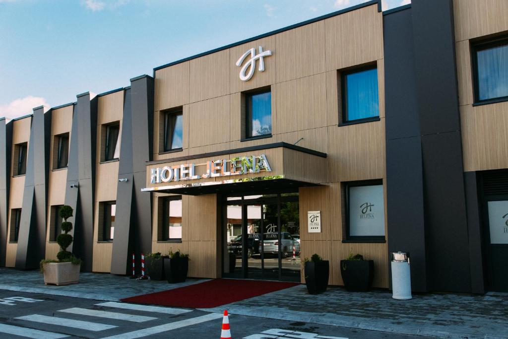 a hotel building with a sign on the front of it at Hotel Jelena in Banja Luka