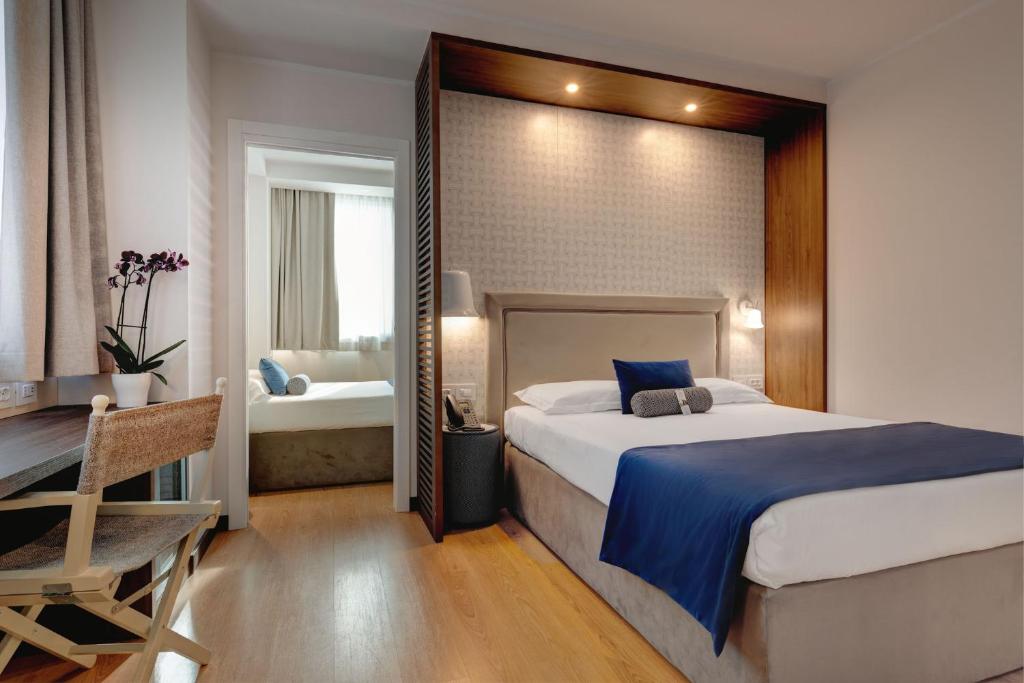 Postel nebo postele na pokoji v ubytování Fly Decó Hotel