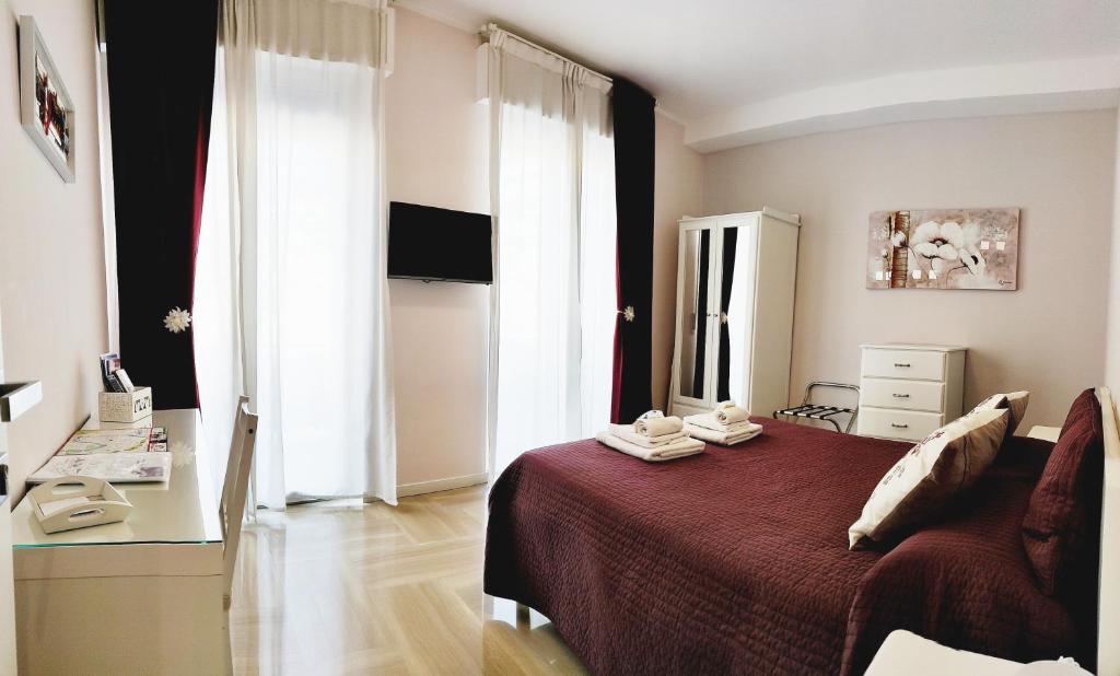 a bedroom with a bed with a red comforter at B&B Valverde in Verona