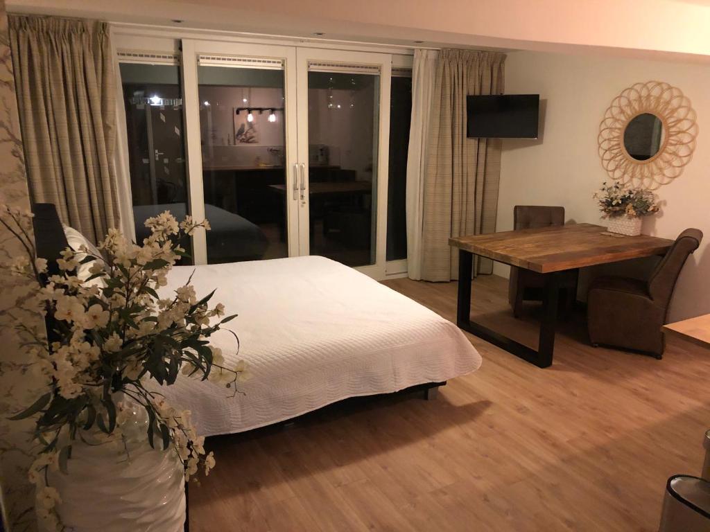 アムステルダムにあるGarden Room and Economy Roomのベッドルーム1室(ベッド1台、テーブル、デスク付)