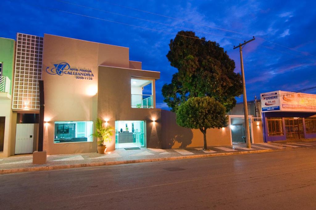 a building on the side of a street at night at Hotel Pousada Calliandra in Bonito