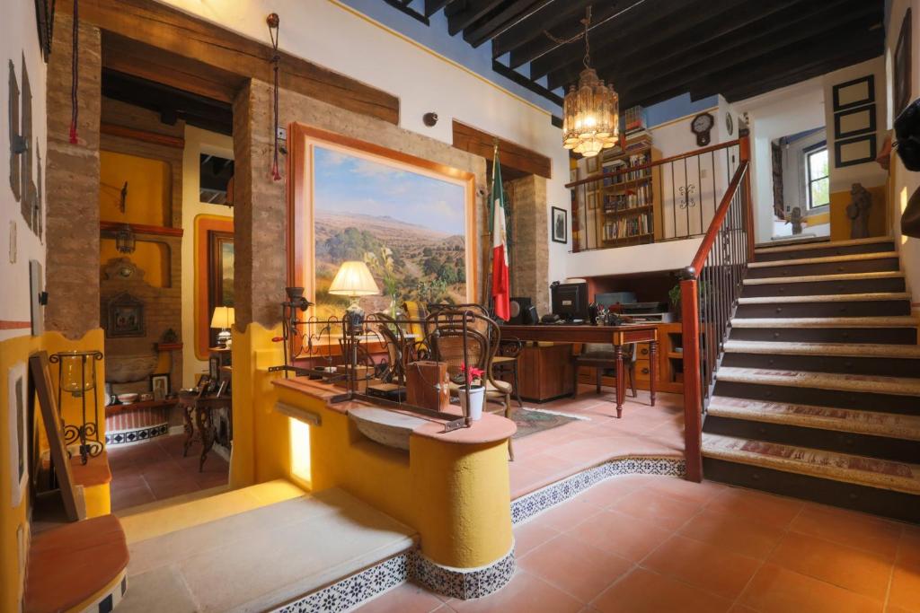 a living room with a staircase and a dining room at Sanbernabé tres in Guanajuato