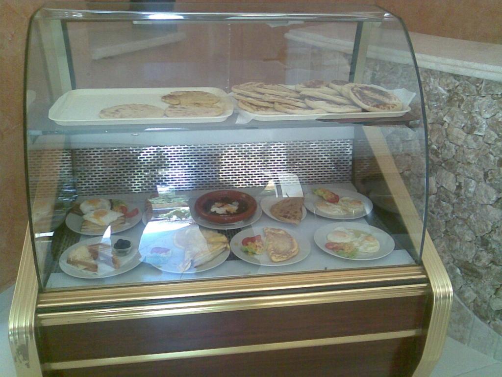 a display case filled with different types of food at Hotel Porte Atlas in Imouzzer du Kandar