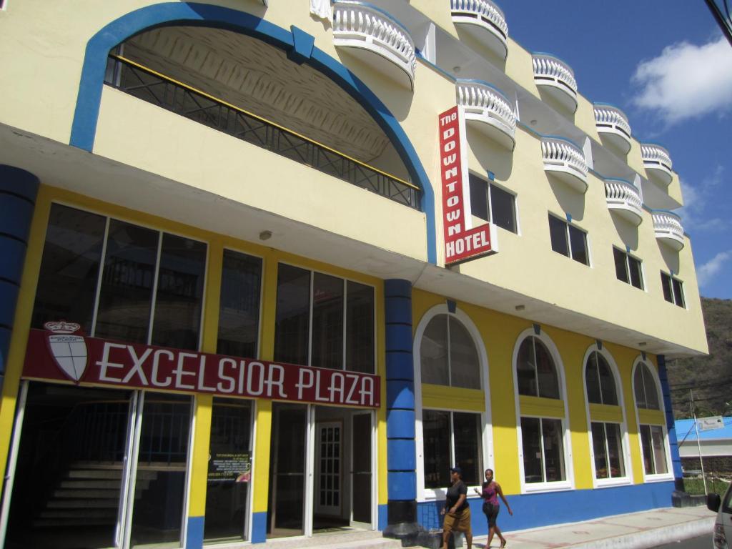 a building with people walking in front of it at The Downtown Hotel in Soufrière