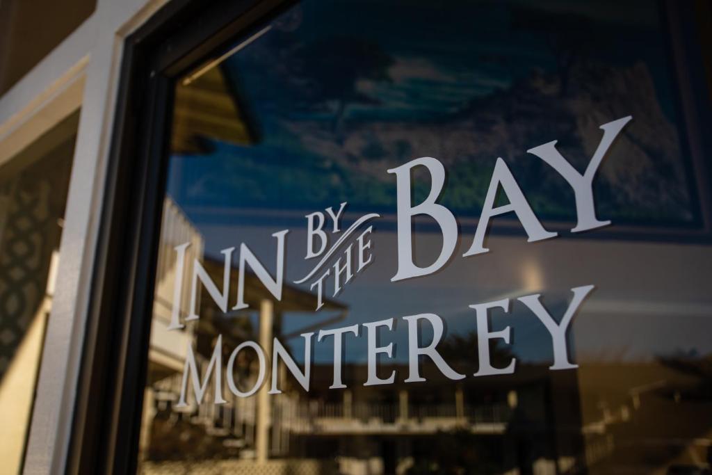 a window with the words by bay in the entrance to a store at Inn By the Bay Monterey in Monterey