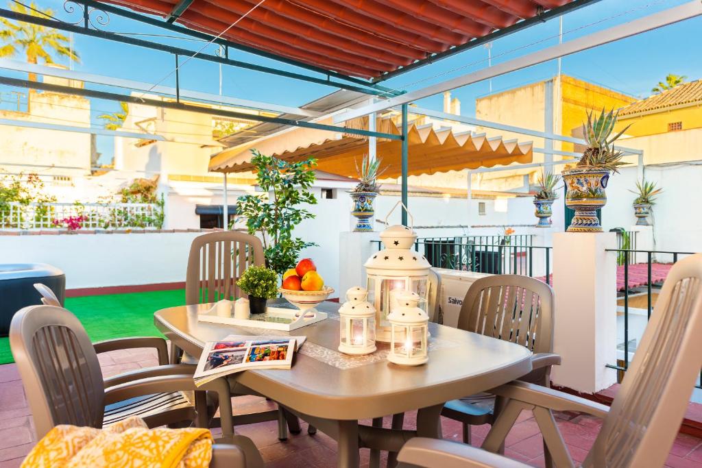 a table and chairs on a patio at HSH Suites Barrio Santa Cruz in Seville