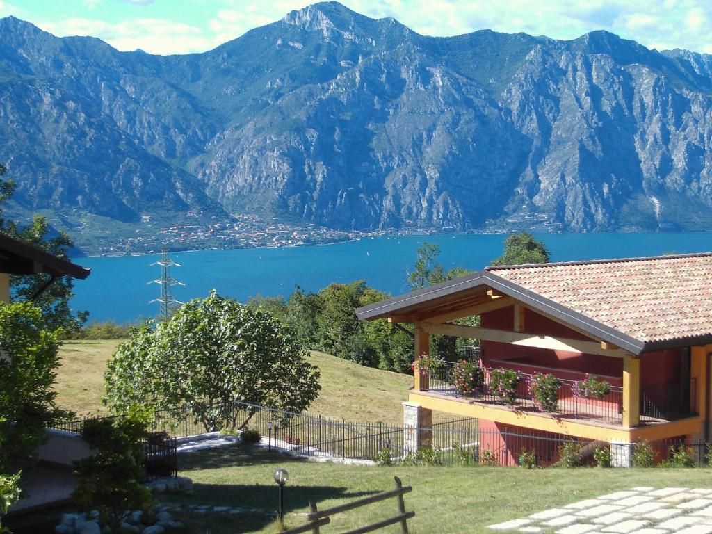 a house with a view of a lake and mountains at Agriturismo San Maggiore in Malcesine