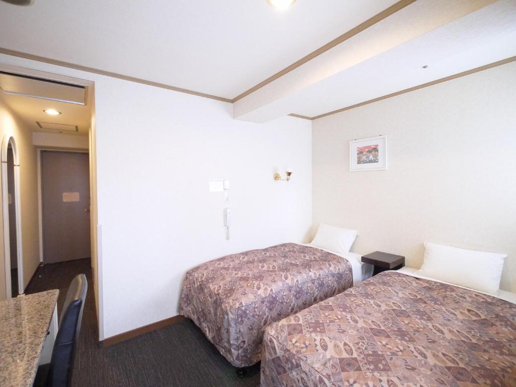 Postel nebo postele na pokoji v ubytování U-Community Hotel