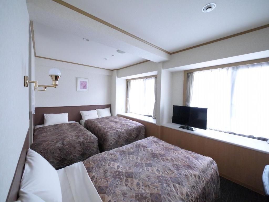 Postel nebo postele na pokoji v ubytování U-Community Hotel