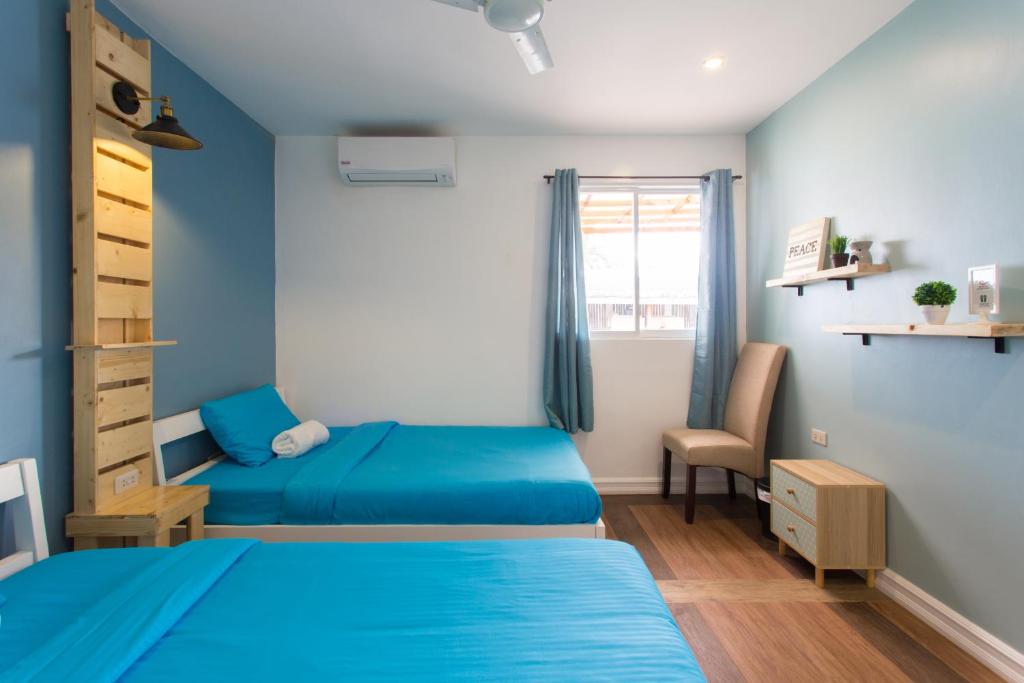 Postel nebo postele na pokoji v ubytování Kalachuchi Inn 薄荷雞蛋花旅宿