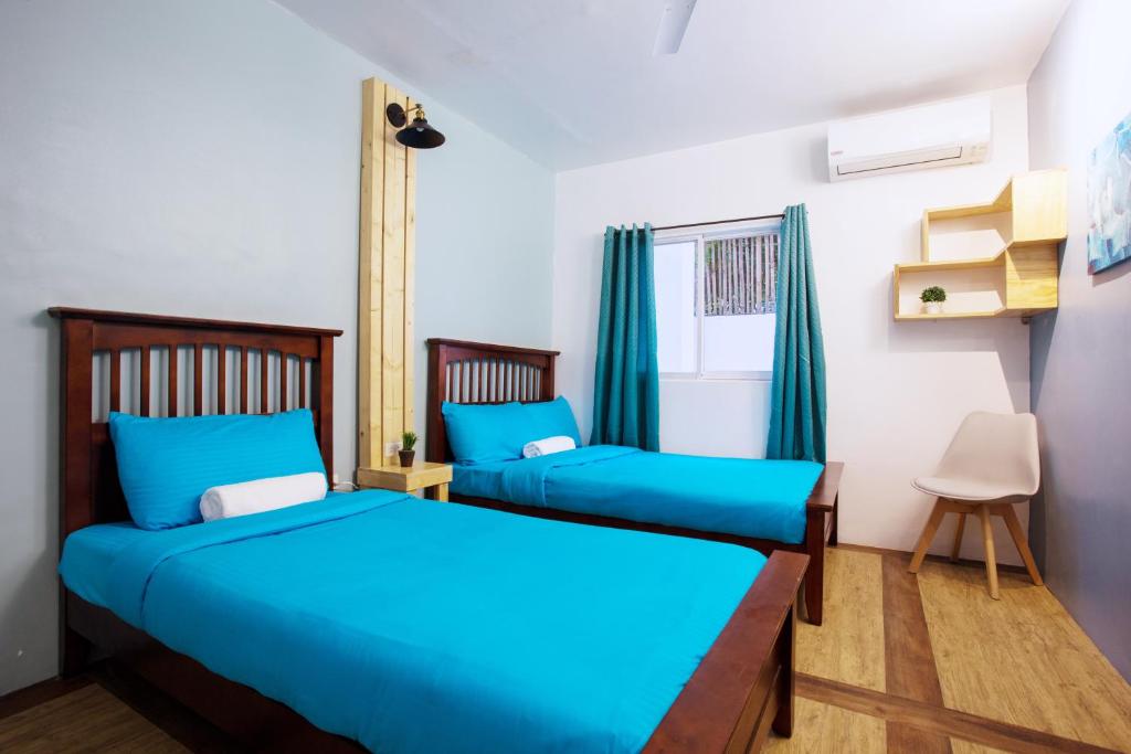 Postel nebo postele na pokoji v ubytování Kalachuchi Inn 薄荷雞蛋花旅宿