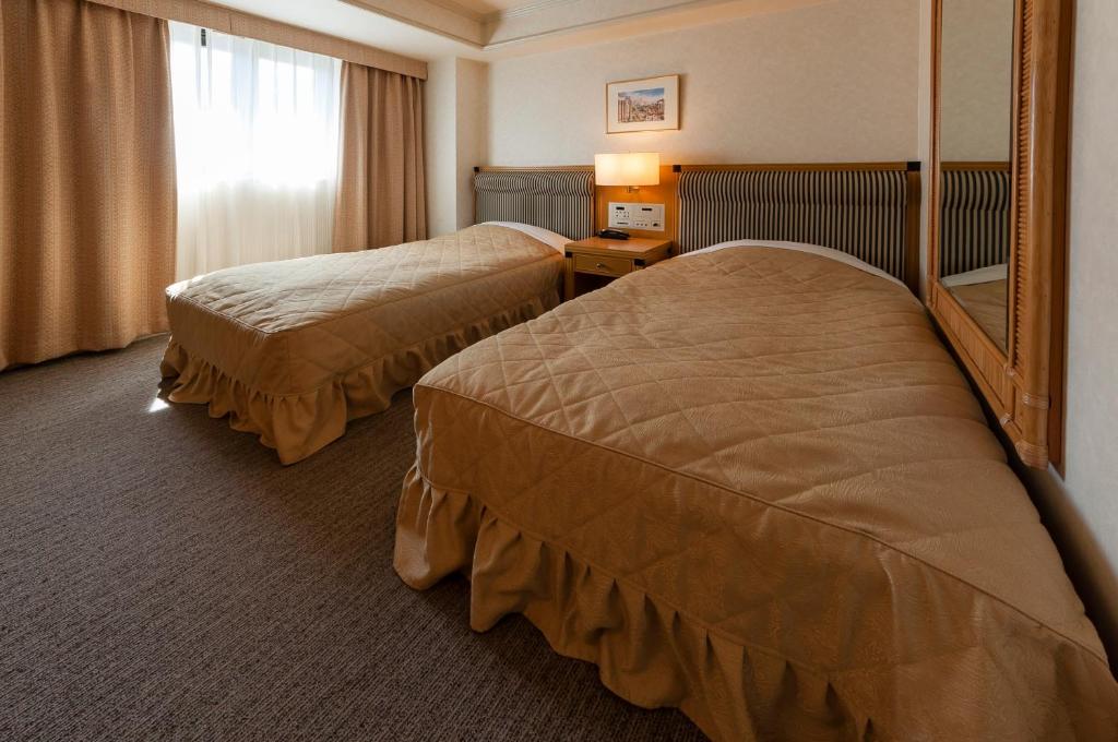Postel nebo postele na pokoji v ubytování Hotel Siena