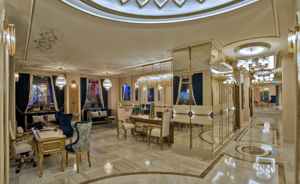 a living room with a table and chairs at Romance Istanbul Hotel Boutique Class in Istanbul