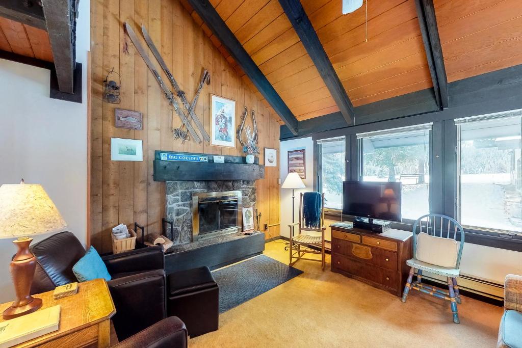 a living room with a couch and a fireplace at Yellowstone 28B in Big Sky