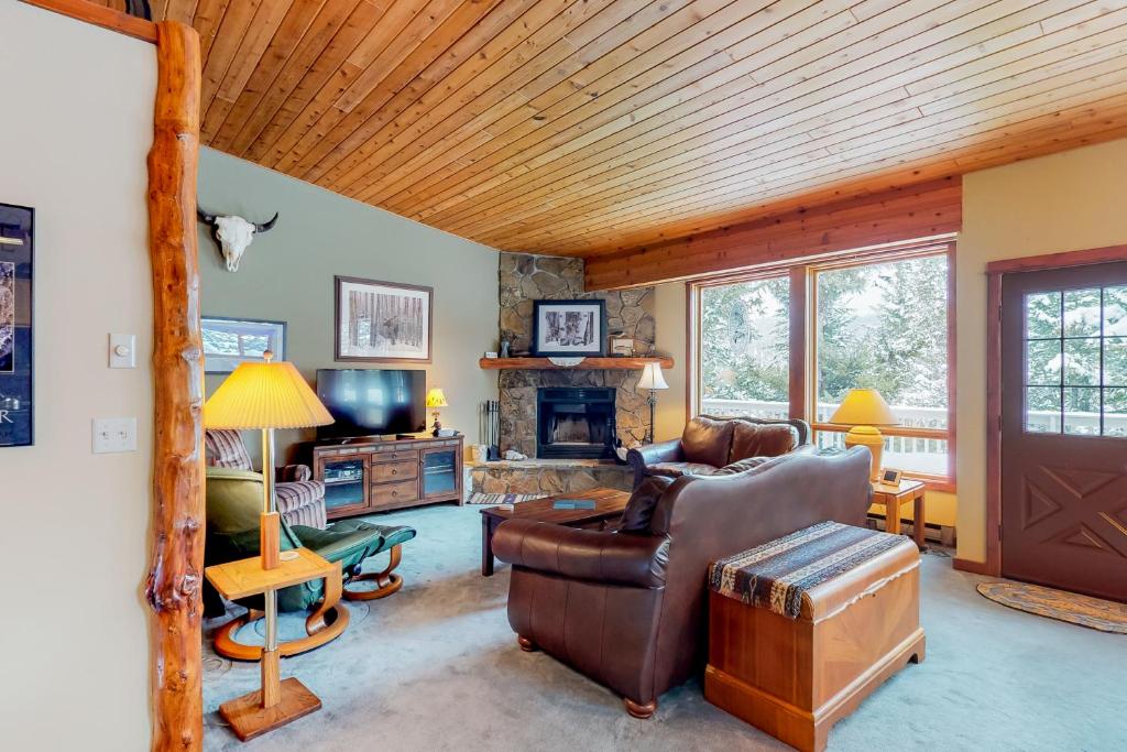 a living room with a couch and a fireplace at Hidden Village 20 in Big Sky