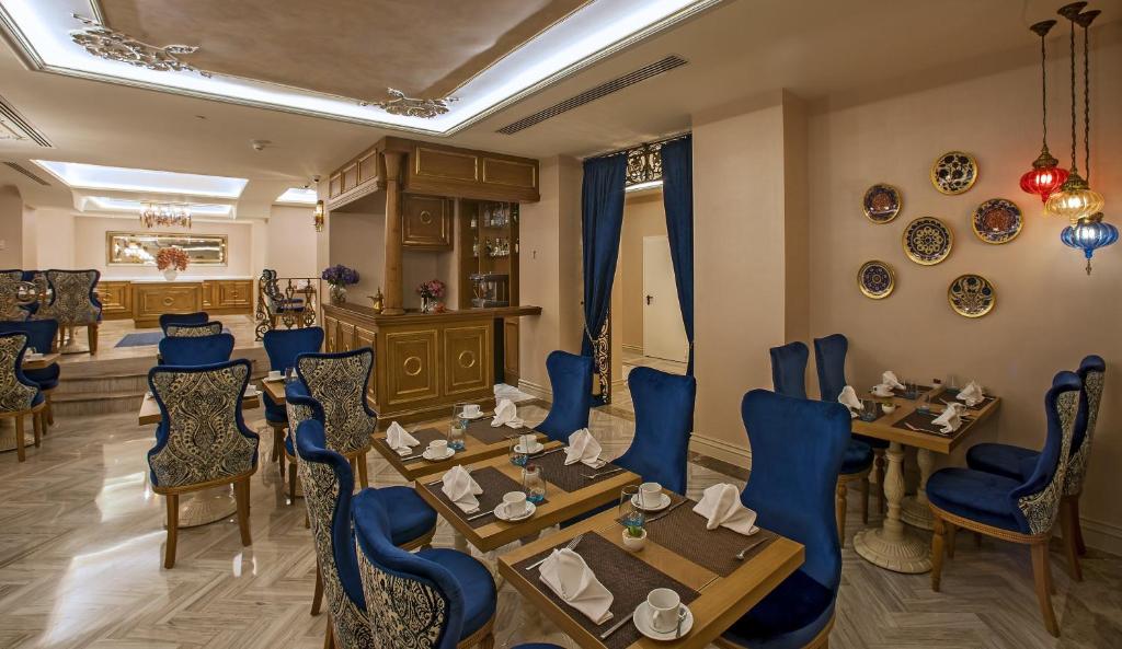 a restaurant with blue chairs and tables in a room at Romance Istanbul Hotel Boutique Class in Istanbul
