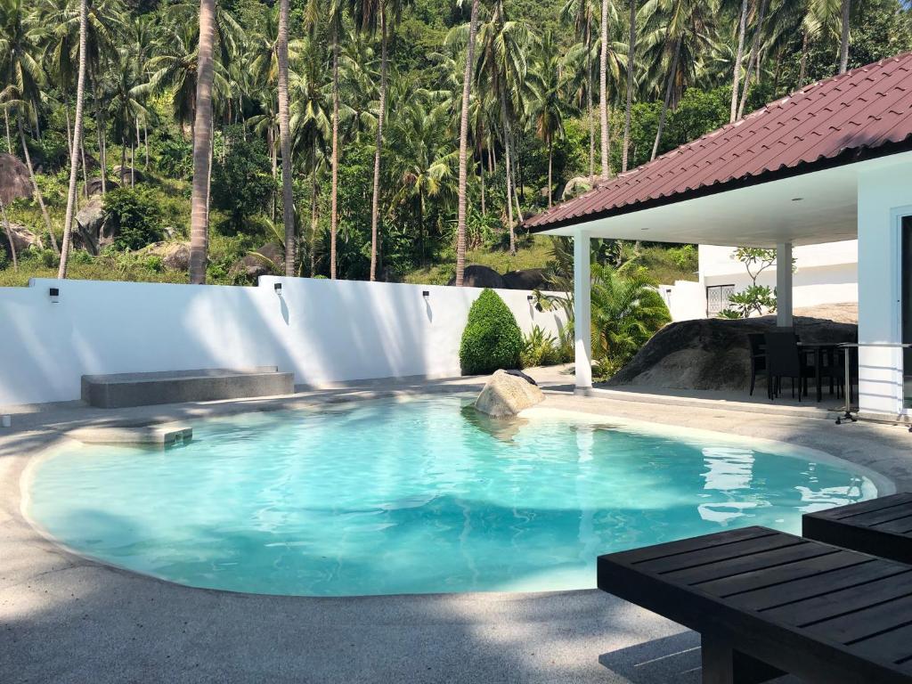 a swimming pool in a yard with a white fence at Villa MAORA 3 Bedrooms with Private Pool in Lamai