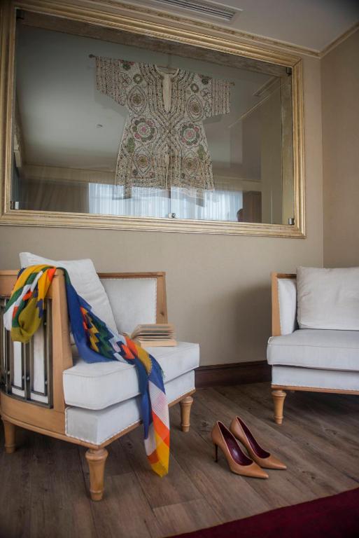 a living room with a mirror and a couch and shoes at Romance Istanbul Hotel Boutique Class in Istanbul