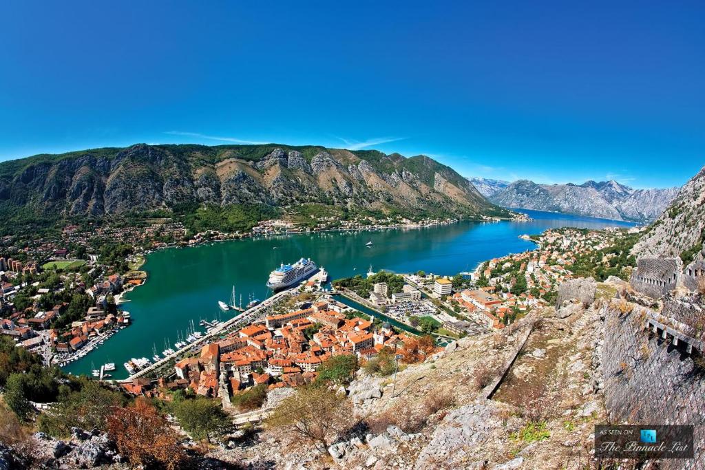 a view of a bay with a cruise ship in the water at Apartment Iv in Kotor