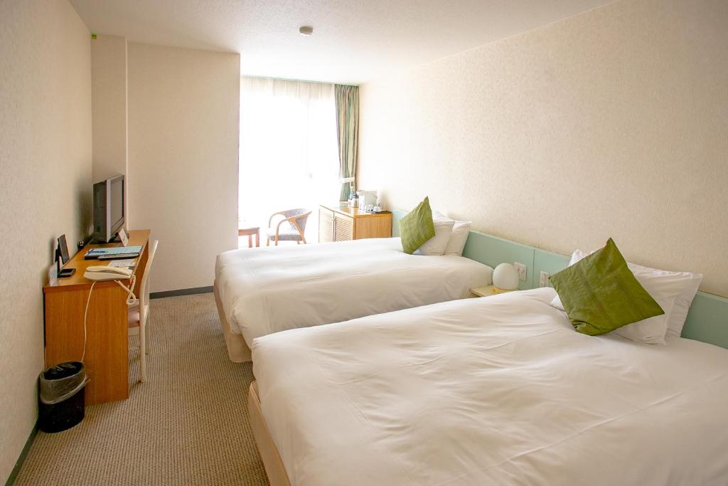 Postel nebo postele na pokoji v ubytování Zekkeino Yado Inubohsaki Hotel