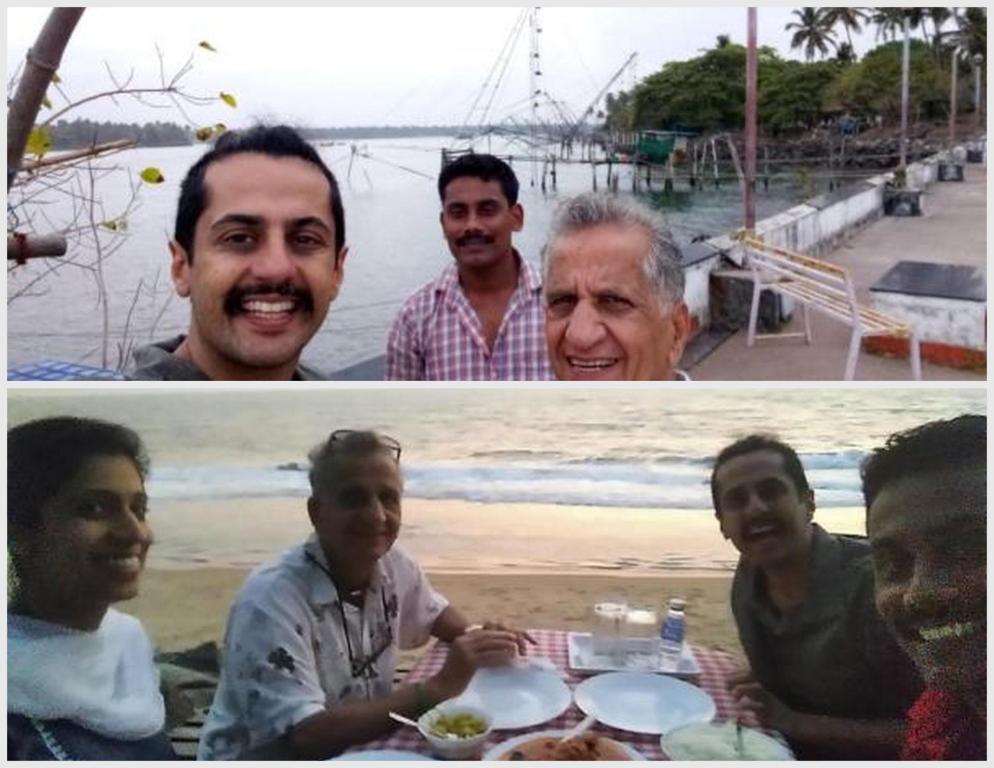 a group of people sitting at a table on the beach at Cherai Ocean View Home in Cherai Beach