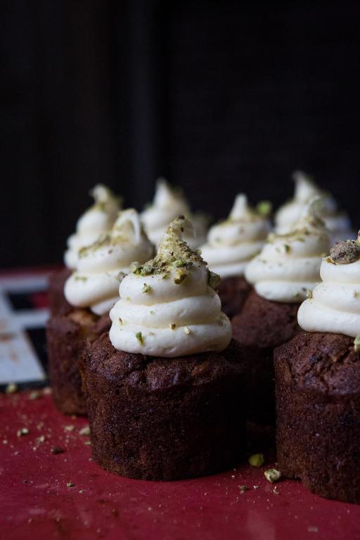 a row of chocolate cupcakes with white frosting at Whitehouse Rye in Rye