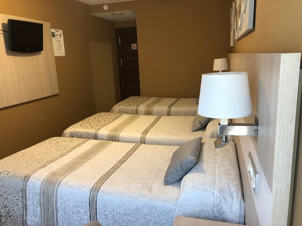 Postel nebo postele na pokoji v ubytování Hotel Bahia