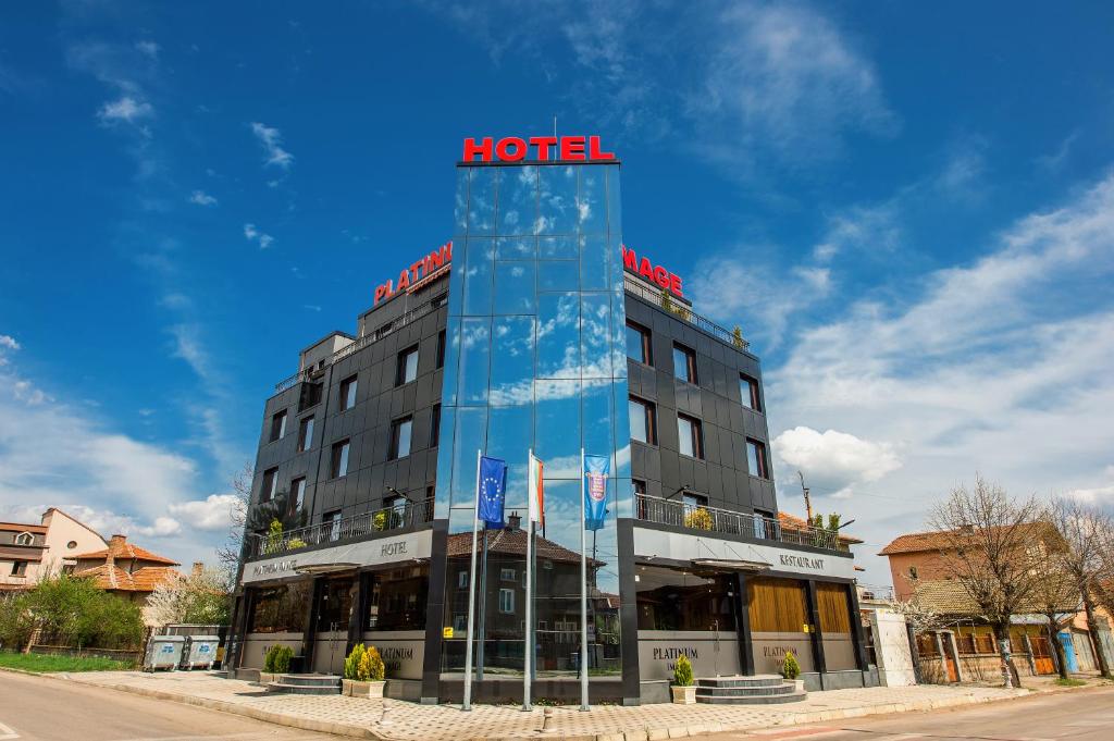a hotel building with a sign on top of it at Platinum Image Hotel in Elin Pelin