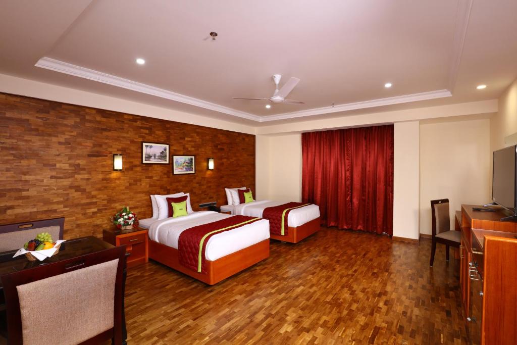 Postel nebo postele na pokoji v ubytování JVK Park Hotel