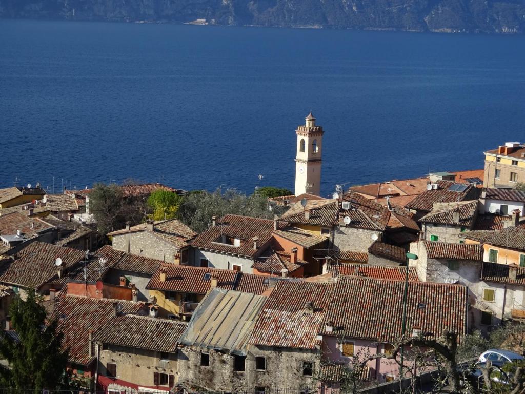 a view of a town with a lighthouse at Dal Mariano in Brenzone sul Garda