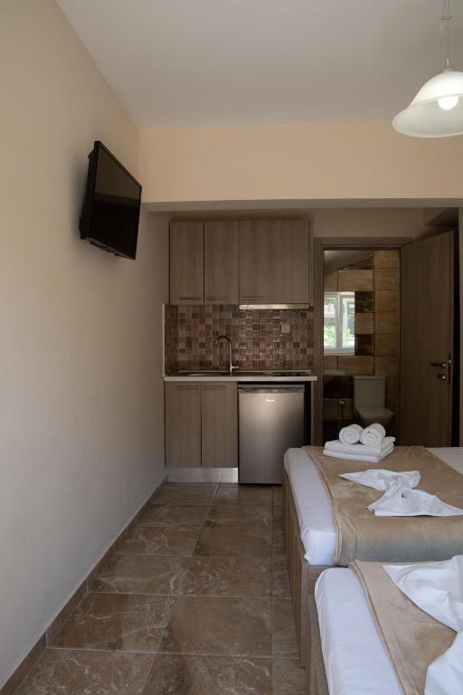 a hotel room with two beds and a kitchen at Olympic Coast in Olympic Beach